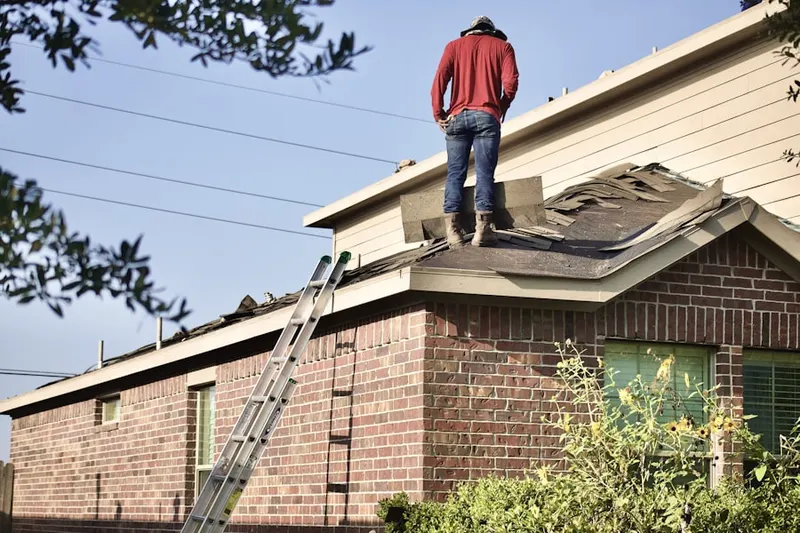 Professional roofer working on a residential roof in Burkinshaws Factory